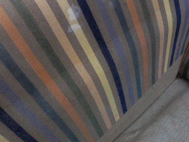 A close up of a striped fabric on a couch.