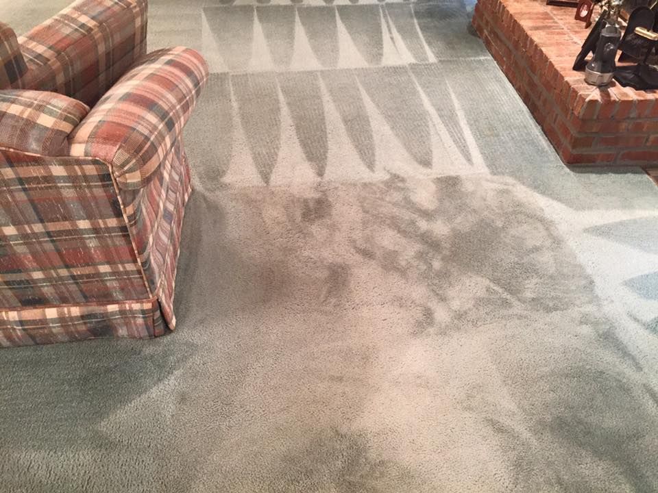 A living room with a couch , chair and fireplace.