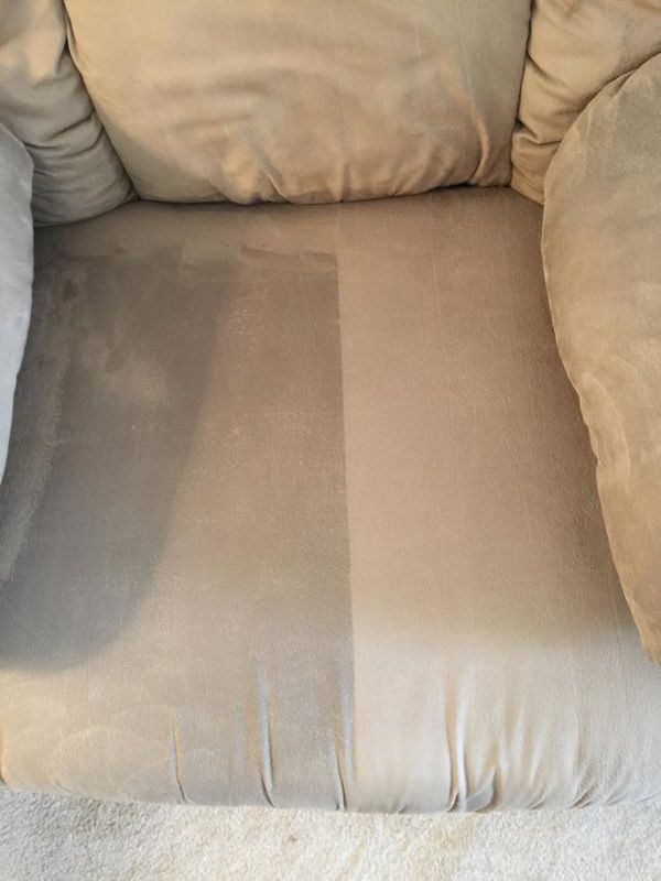 A close up of a chair with a stain on it.