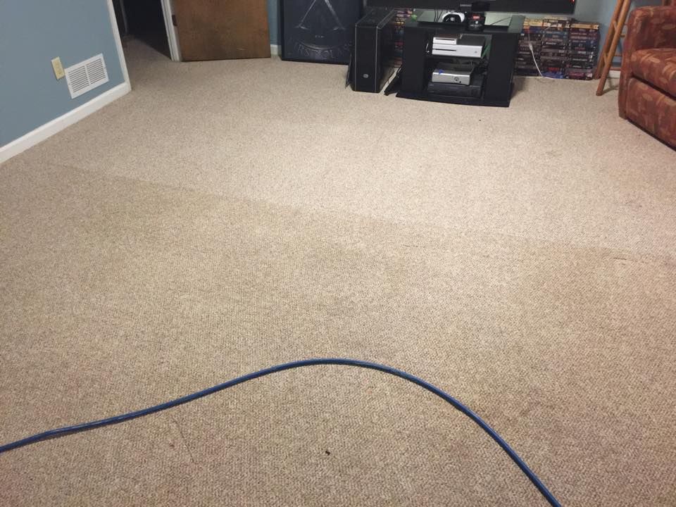 A living room with a couch and a tv stand