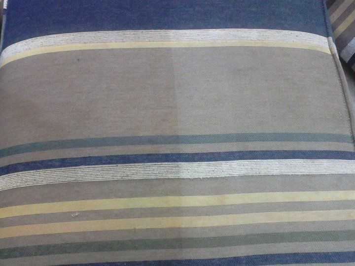 A close up of a striped fabric on a couch