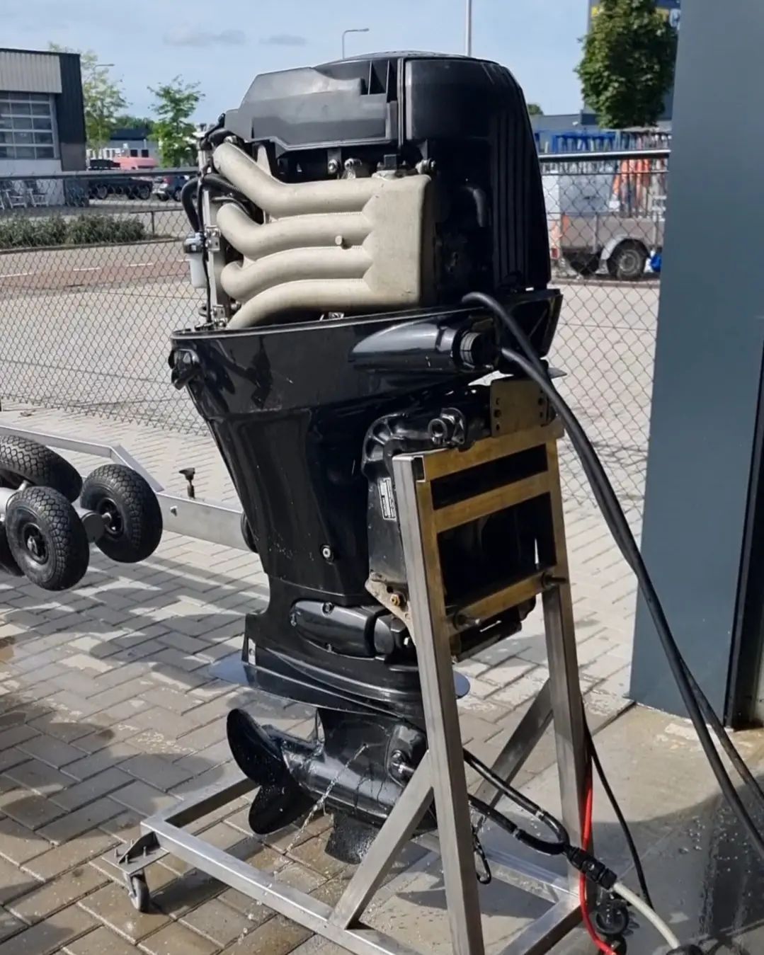 Een bootmotor staat op een metalen standaard.