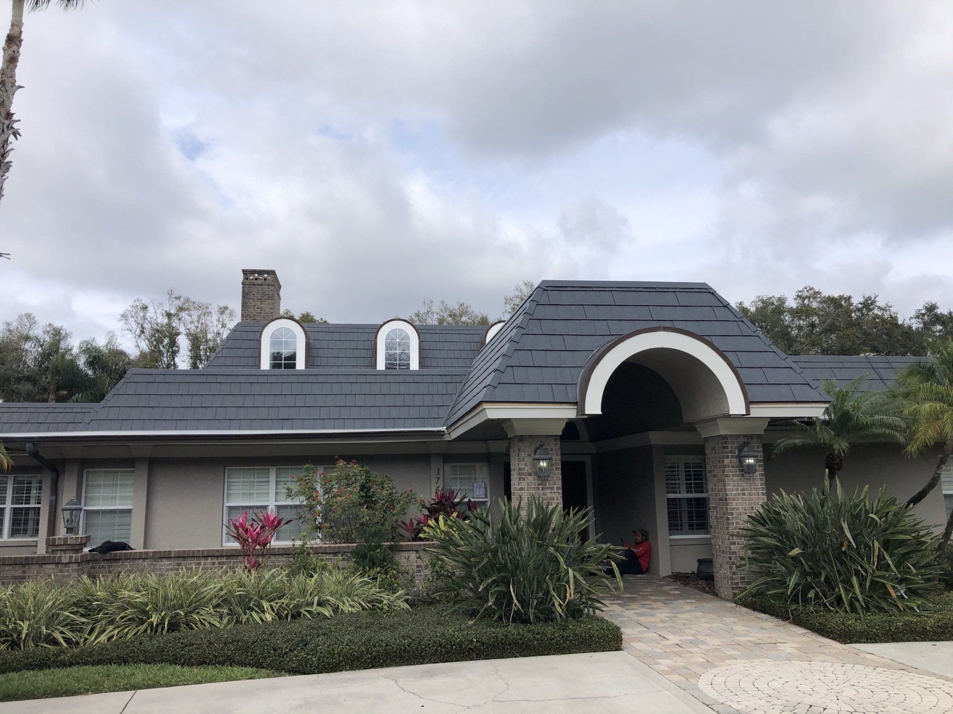 A large house with a blue roof and white trim