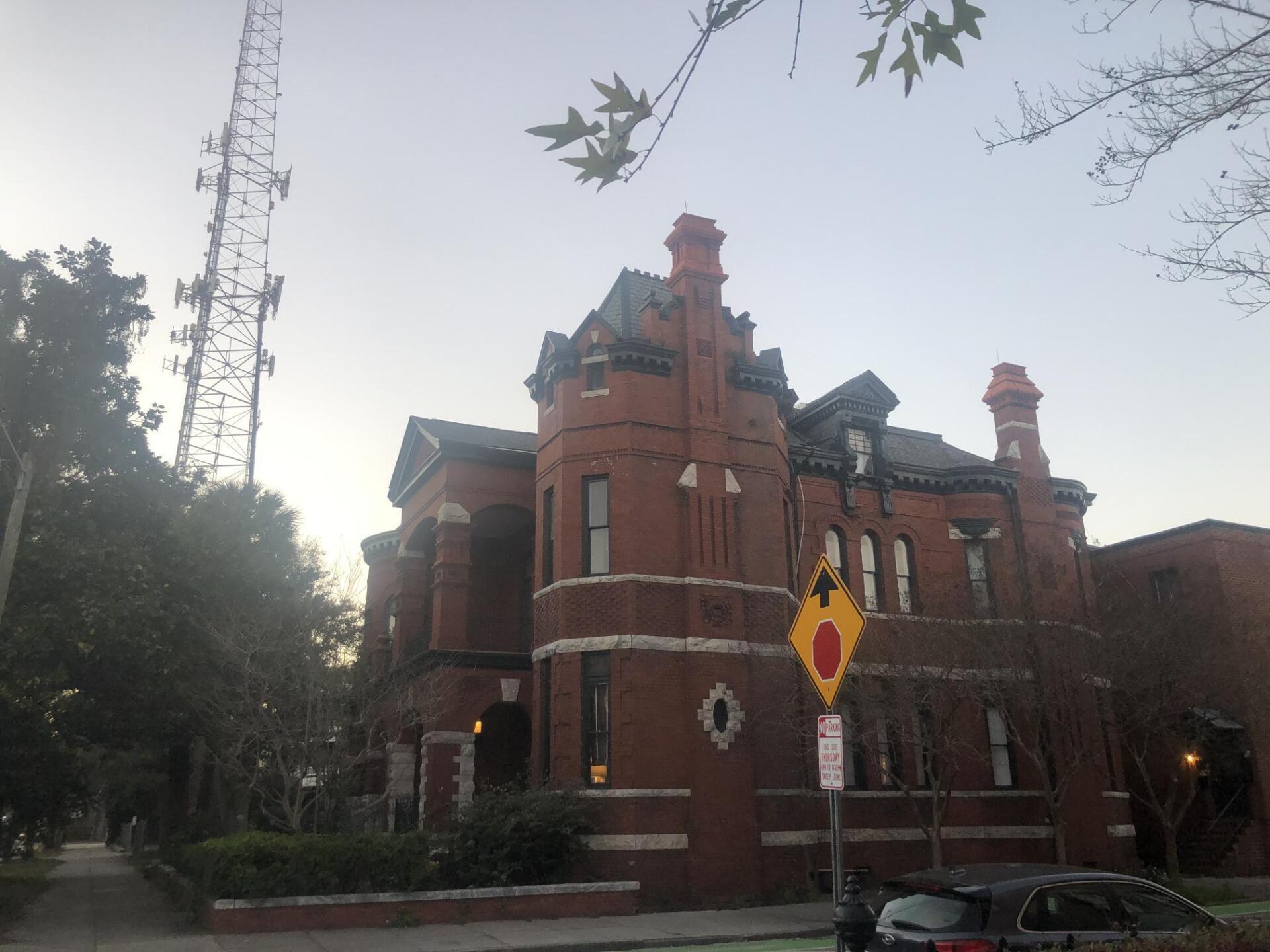 A large brick building with a no parking sign in front of it