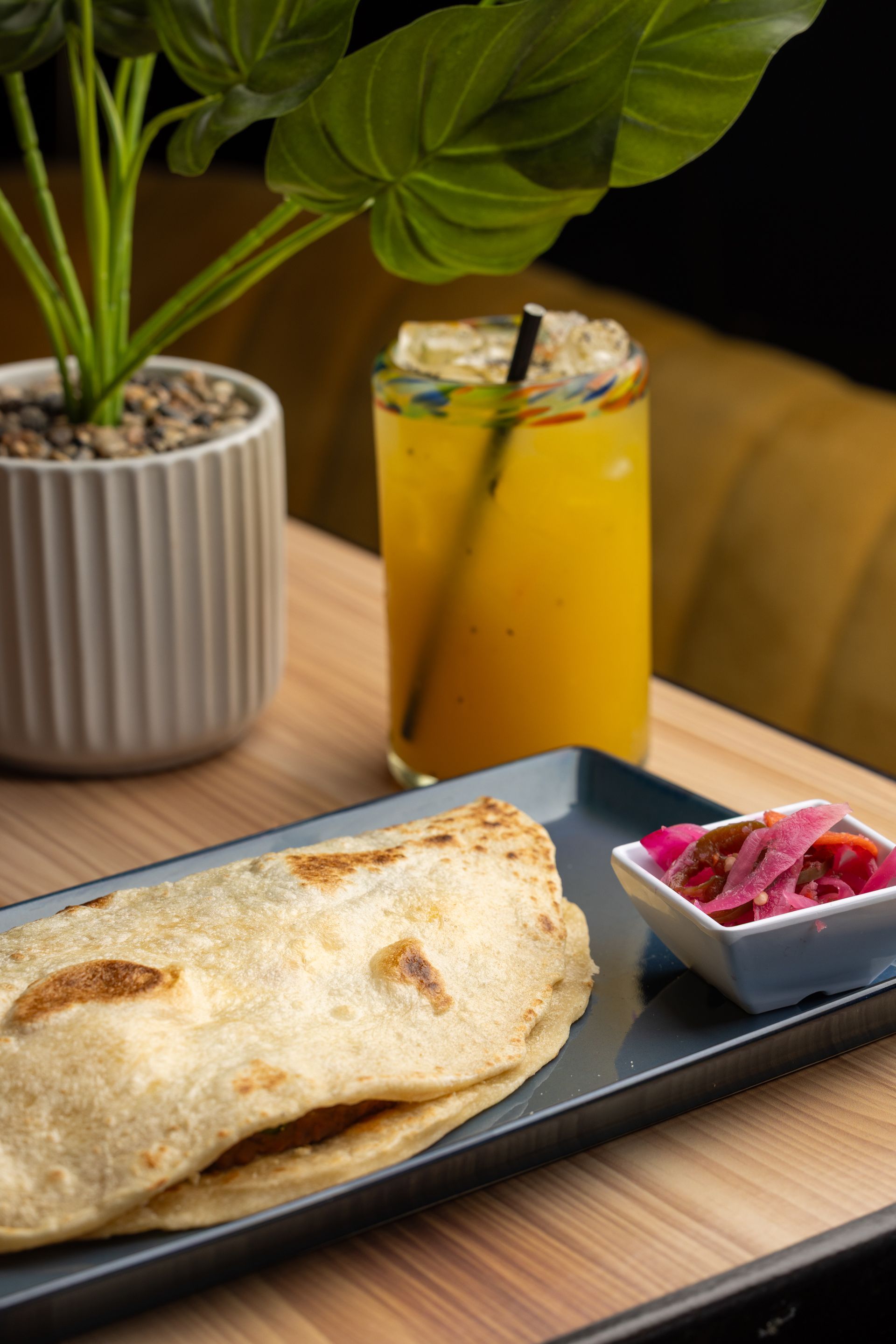 A close up of a plate of food and a drink on a table.