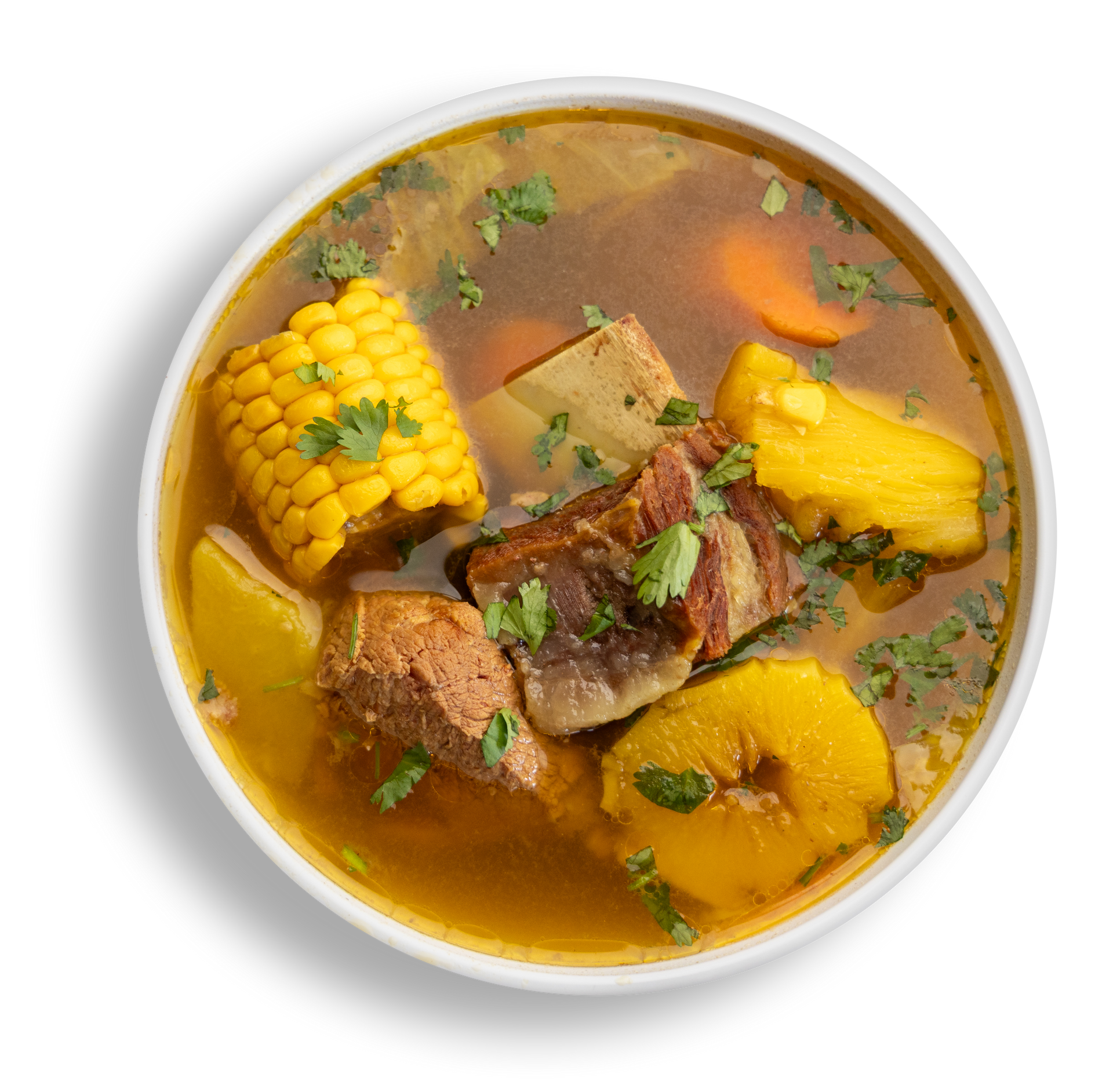 A bowl of soup with meat , corn on the cob , potatoes and carrots.
