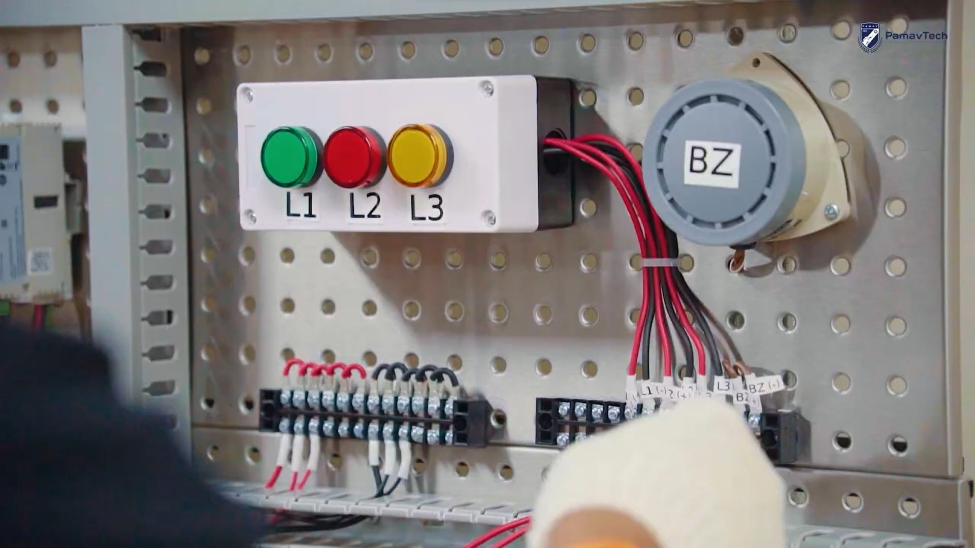 A close up of a person working on a electrical panel.