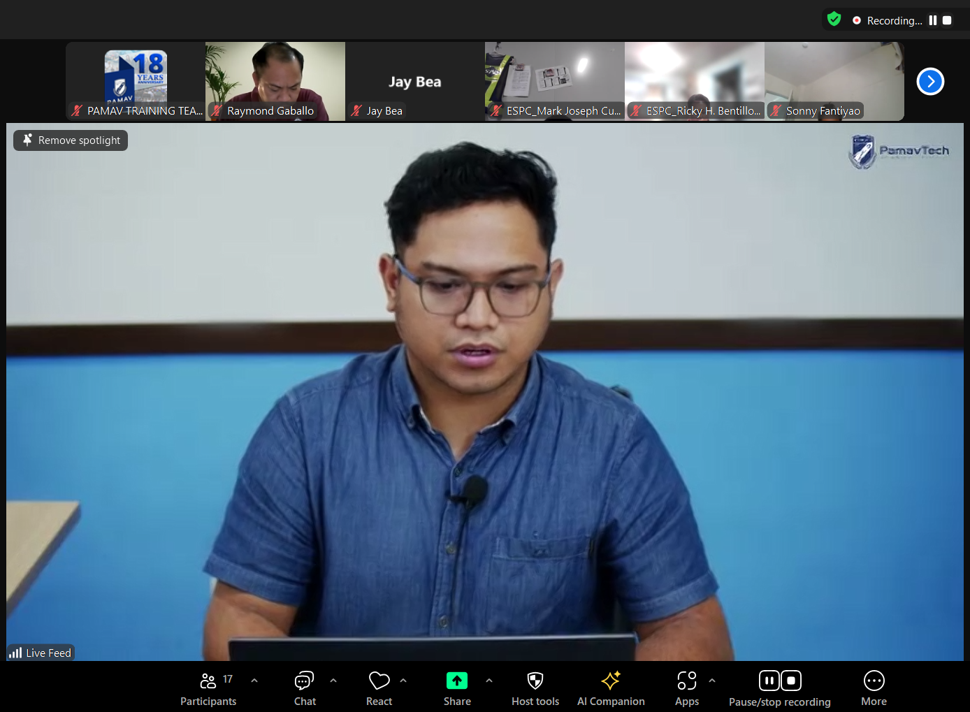A man wearing glasses is sitting in front of a computer screen