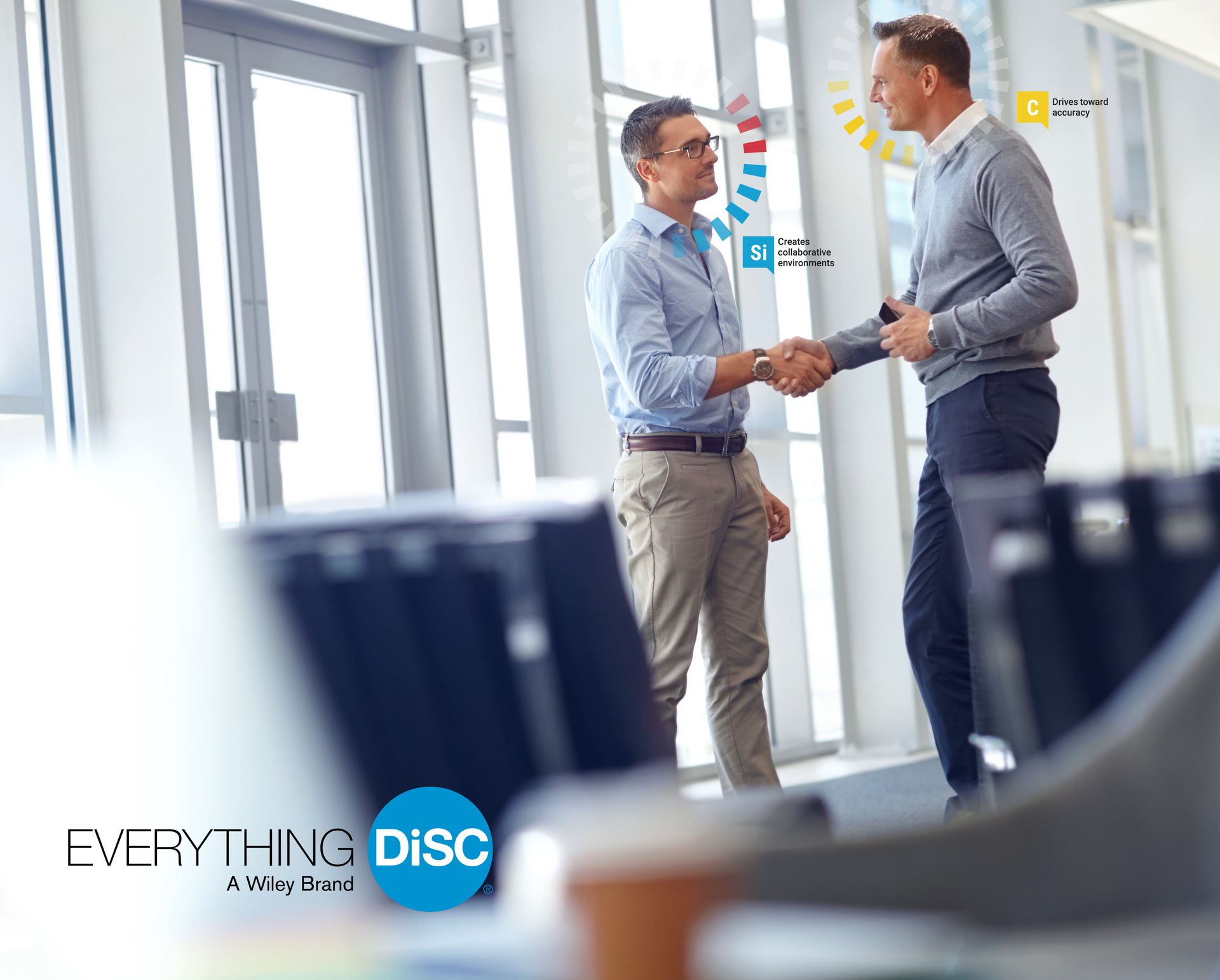 Two men are shaking hands in an office.