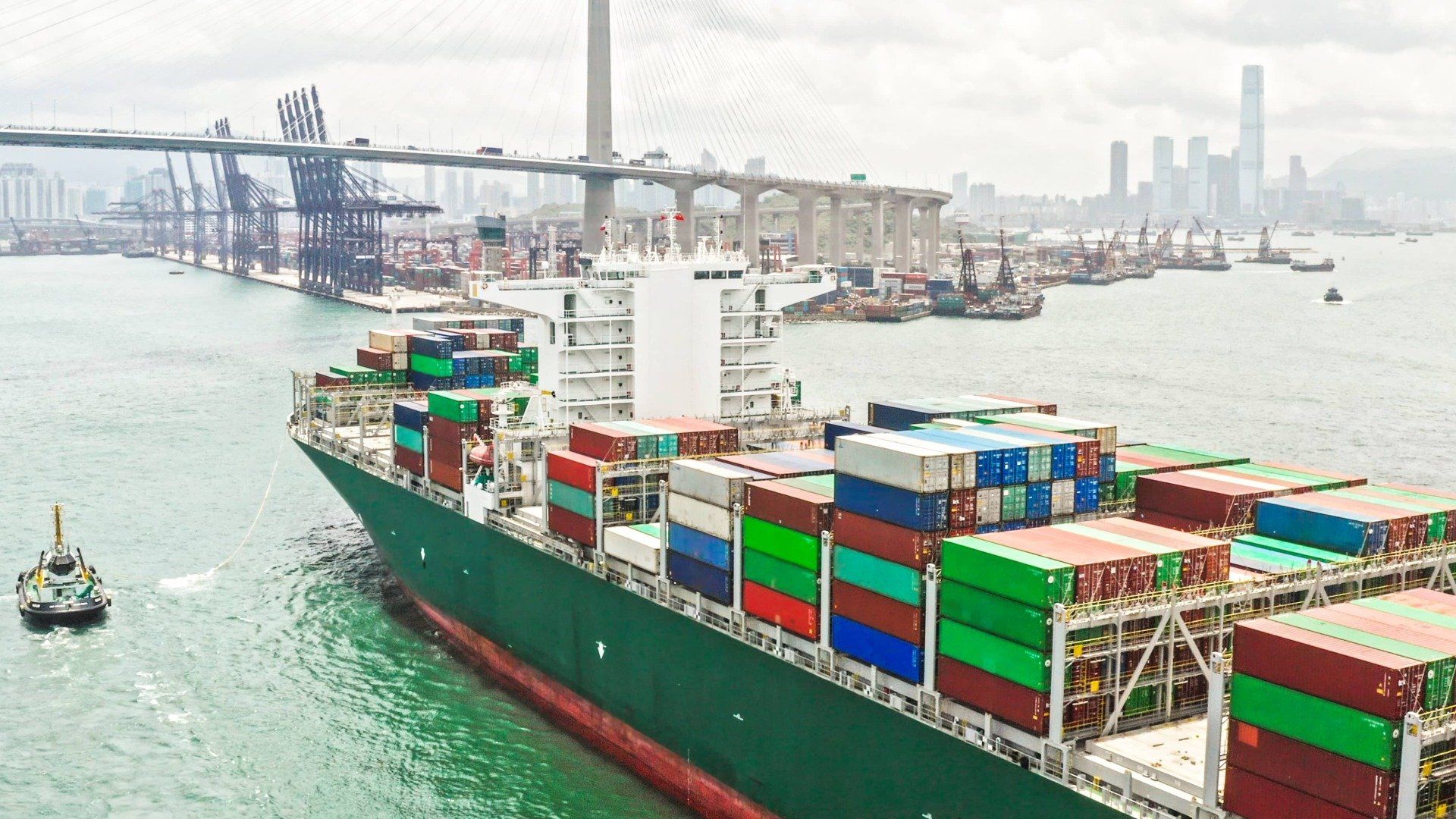 A large container ship is floating on top of a body of water.
