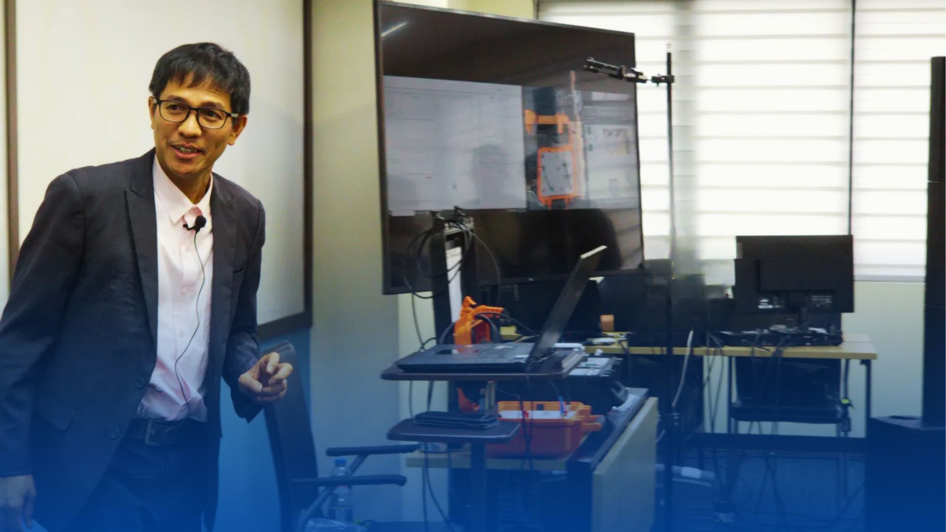 A group of construction workers are standing under a red and blue tarp.