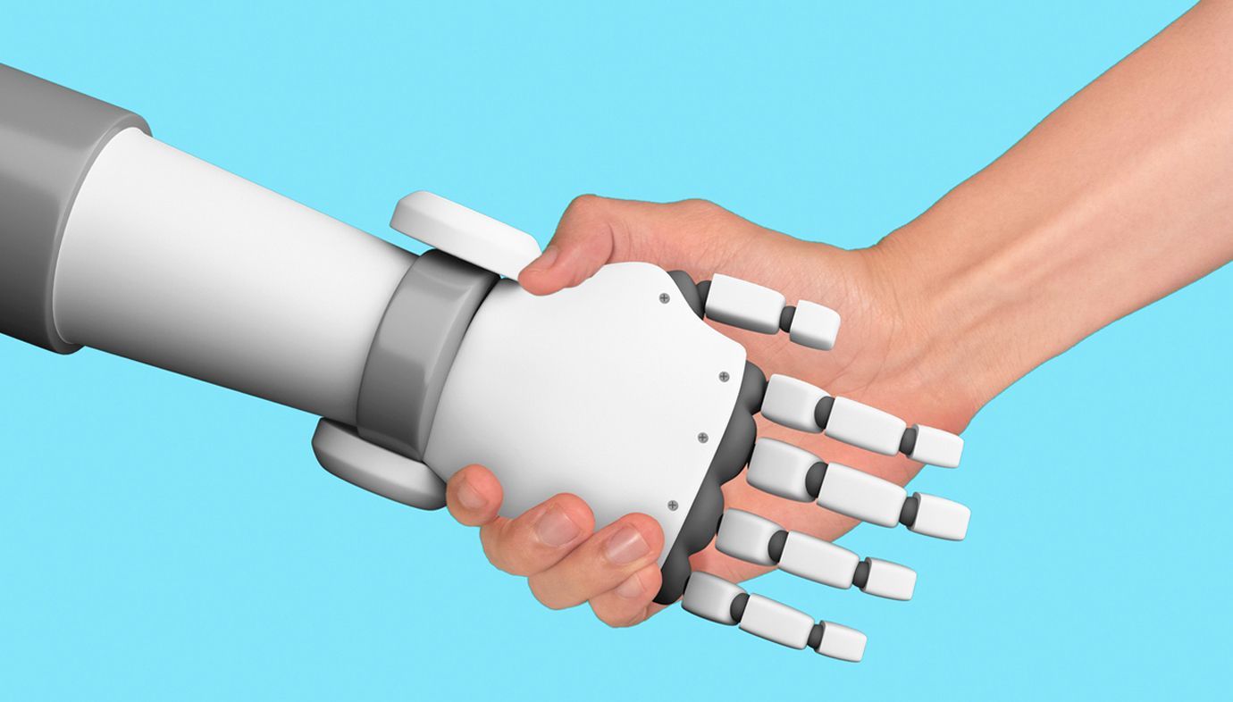 A person is shaking hands with a robotic hand.