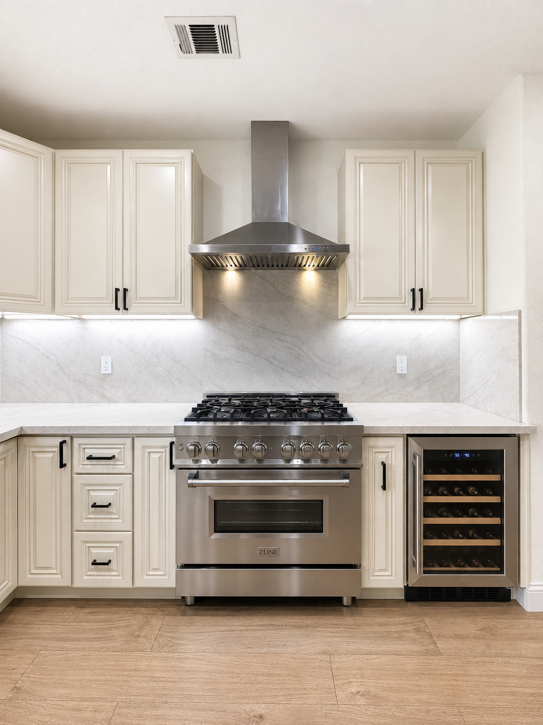 A kitchen with white cabinets and a large island in the middle.