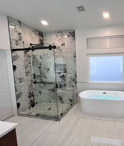 A bathroom with a tub , shower , and toilet.