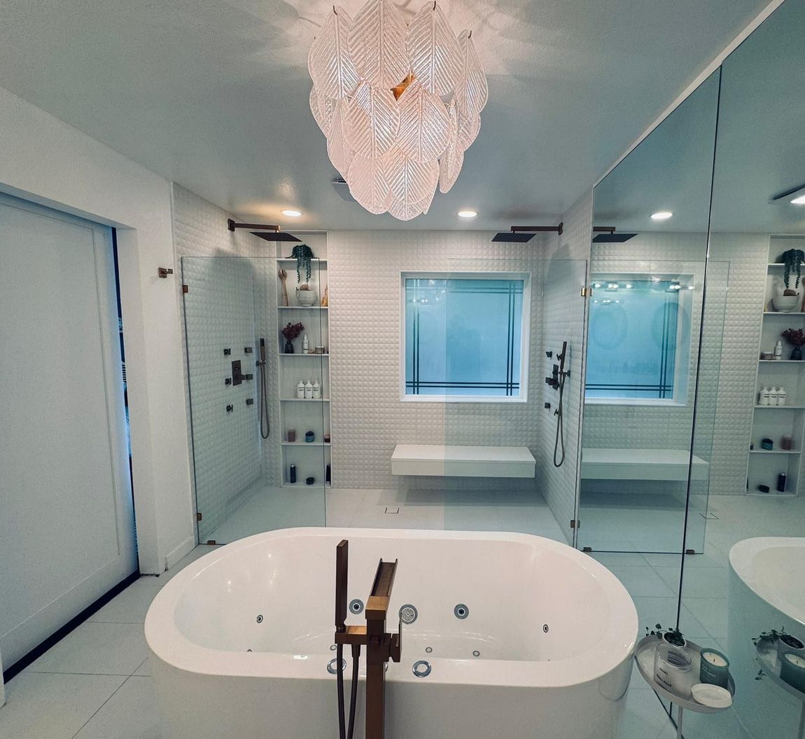 A bathroom with a large tub and a chandelier hanging from the ceiling