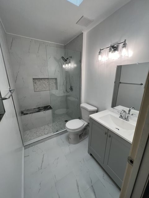 A bathroom with a tub , shower , and toilet.