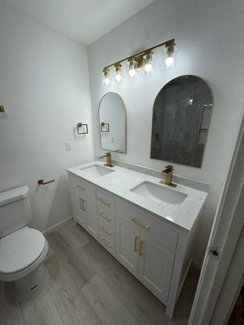 A bathroom with a tub , shower , and toilet.