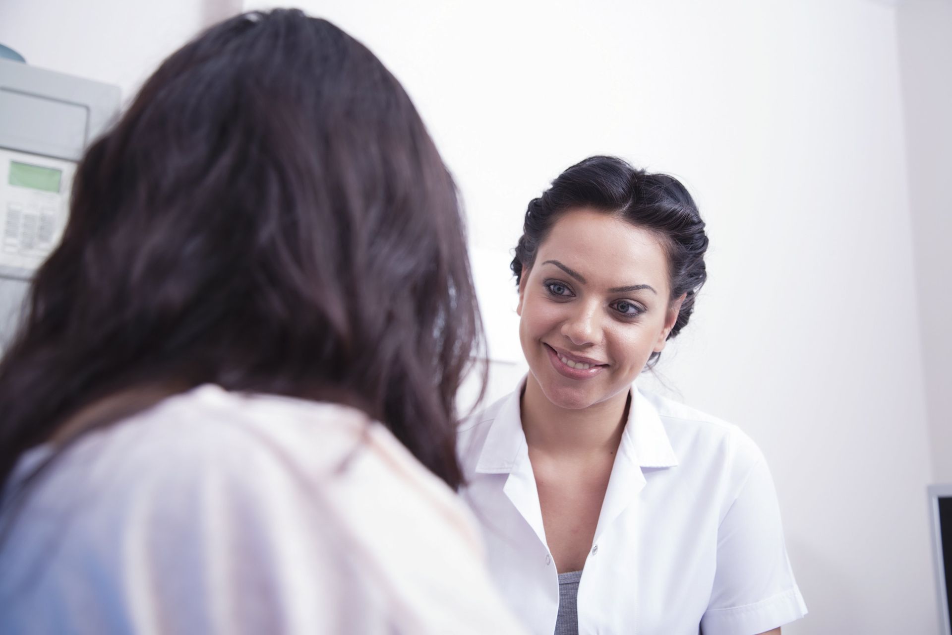 Female doctor and patient speaking before a procedure