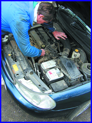 Garage services - Wormley, Broxbourne -Car-Mechanic-working on car engine - MANOR M.O.T.S