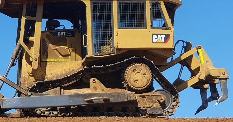 A Cat Bulldozer is Sitting on a Dirt Road — Oakleigh Earthmoving in Cotswold Hills, QLD