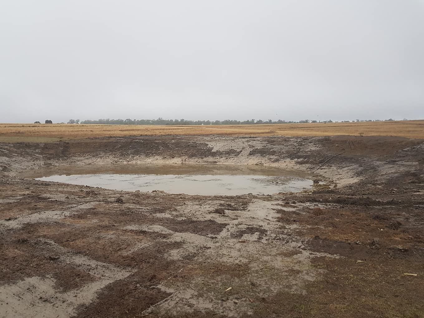 Mudflat With Shallow Puddles Under a Cloudy Sky, Stretching to a Distant Horizon — Oakleigh Earthmoving in Toowoomba, QLD