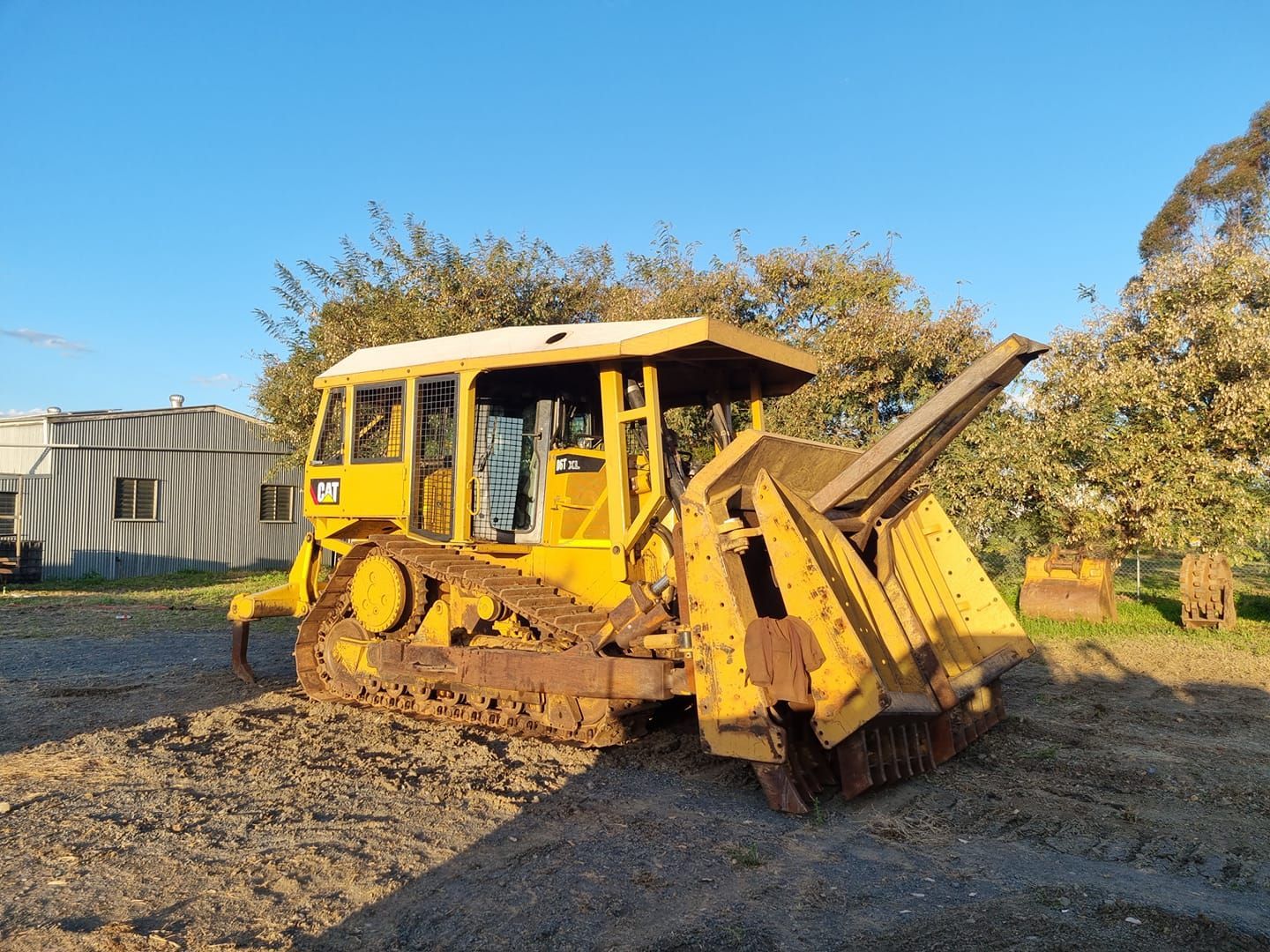 Yellow Bulldozer on a Dirt Lot, With Its Front Blade Raised — Oakleigh Earthmoving in Kingaroy, QLD