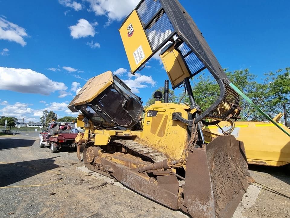 A Bulldozer With Its Hood Up is Parked in a Parking Lot — Oakleigh Earthmoving in Cotswold Hills, QLD