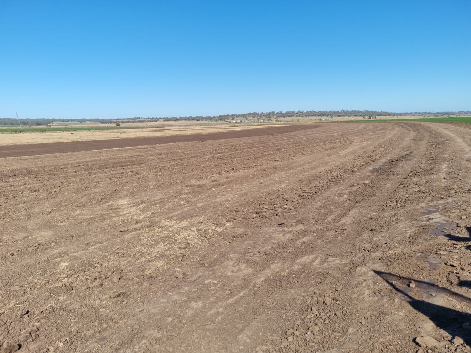 Plowed Brown Field Under a Blue Sky, With Open Farmland Stretching to the Horizon — Oakleigh Earthmoving in Warwick, QLD