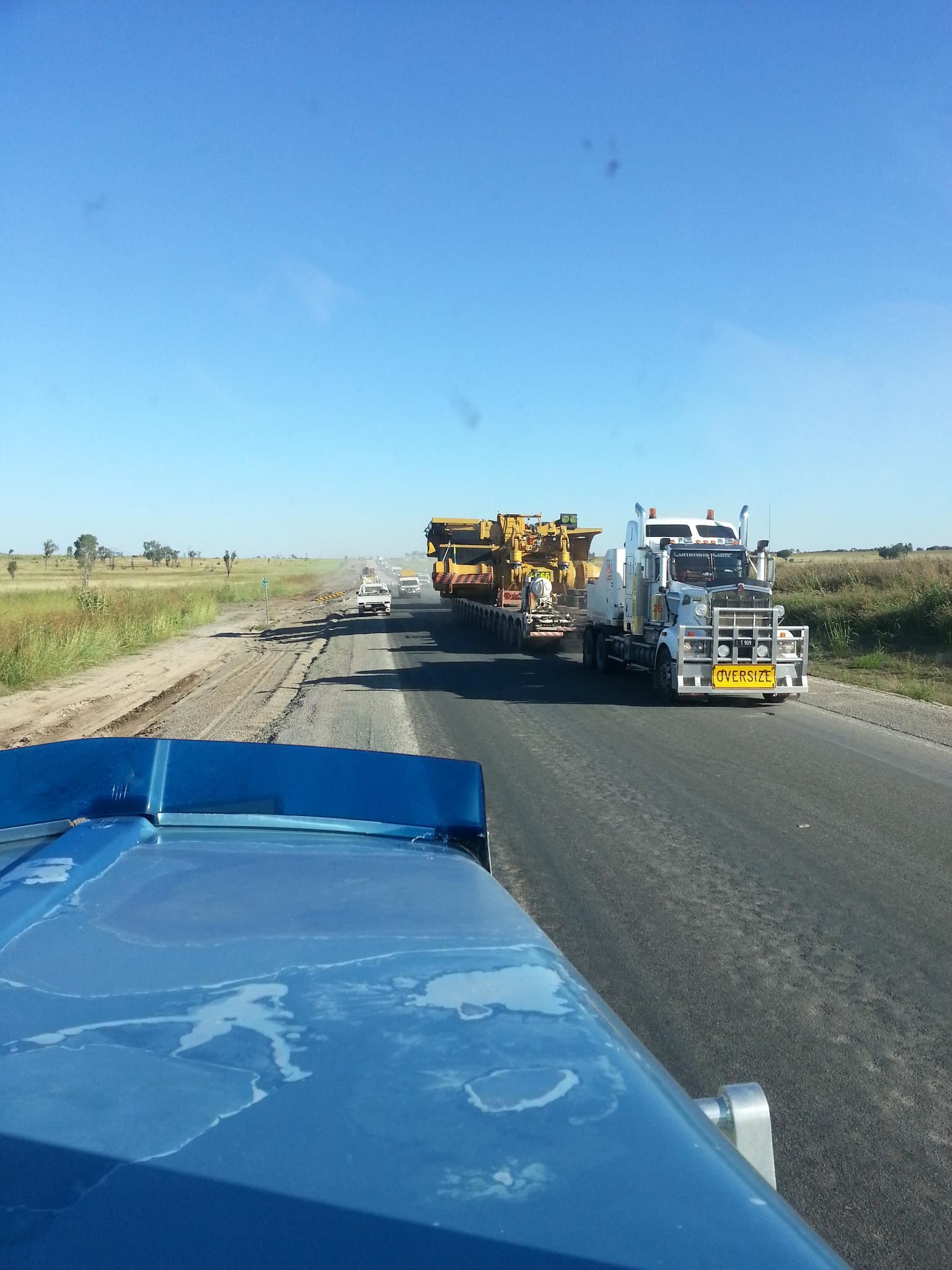 Roadwork on a Rural Highway, With Construction Trucks and Equipment Ahead — Oakleigh Earthmoving in Chinchilla, QLD