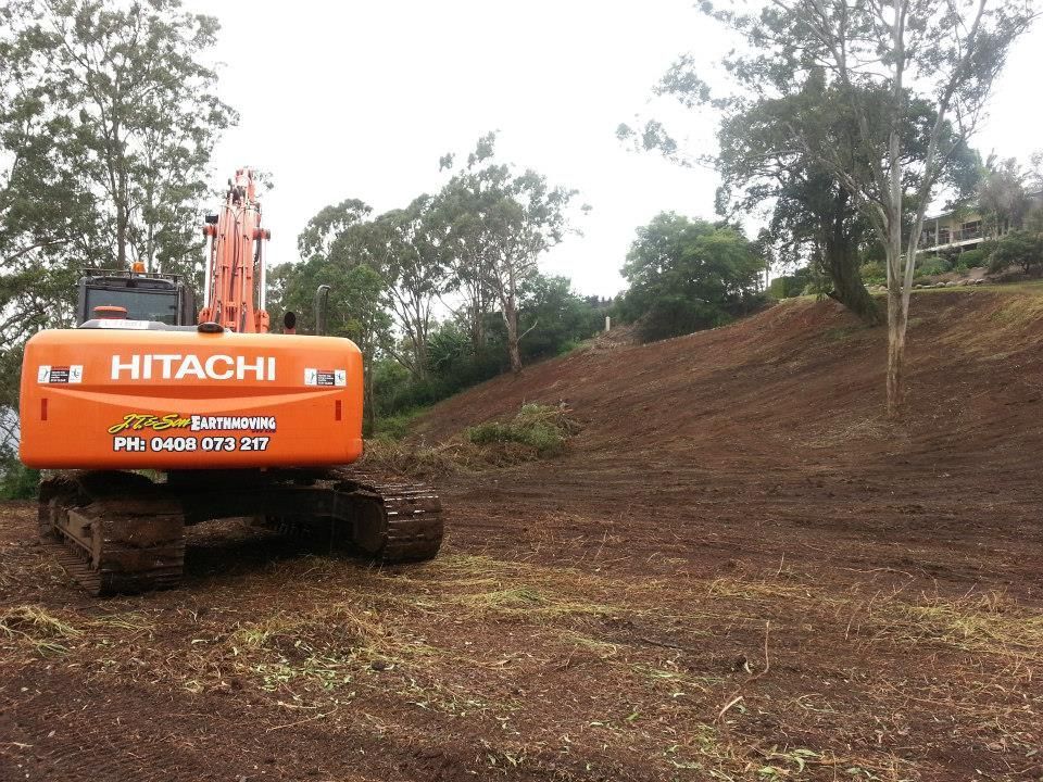 Orange Hitachi Excavator on a Dirt Hillside in a Wooded Clearing — Oakleigh Earthmoving in Moonie, QLD
