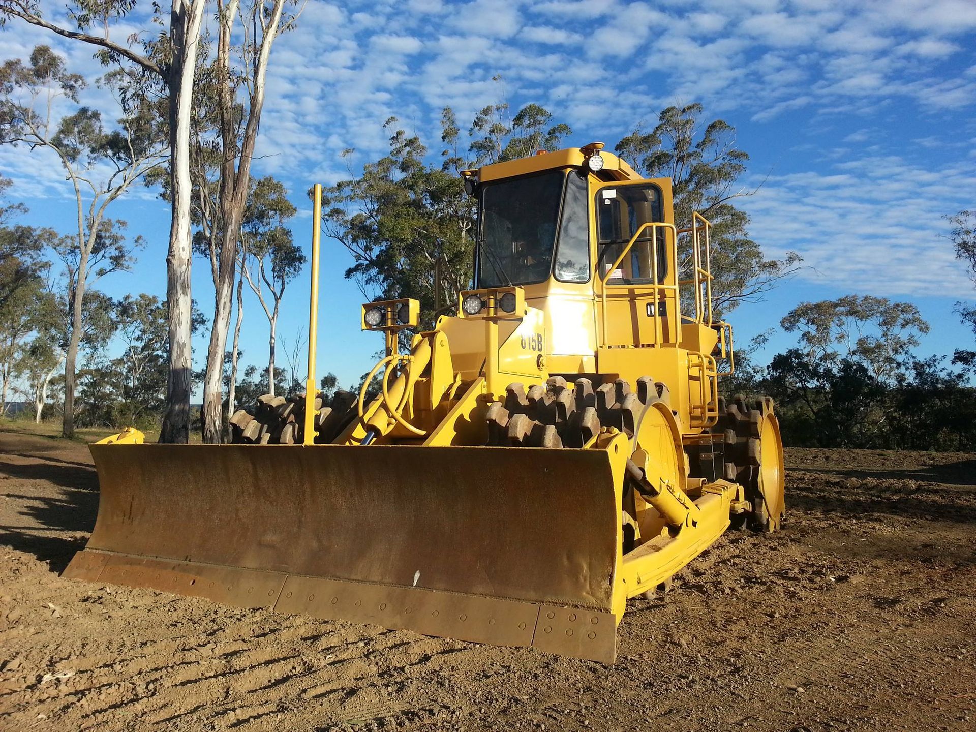 Yellow Bulldozer on a Dirt Lot Under a Blue Sky — Oakleigh Earthmoving in Cotswold Hills, QLD