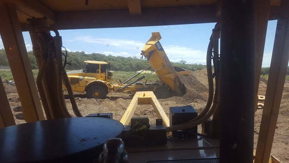 Yellow Dump Truck and Loader at a Construction Site — Oakleigh Earthmoving in Chinchilla, QLD