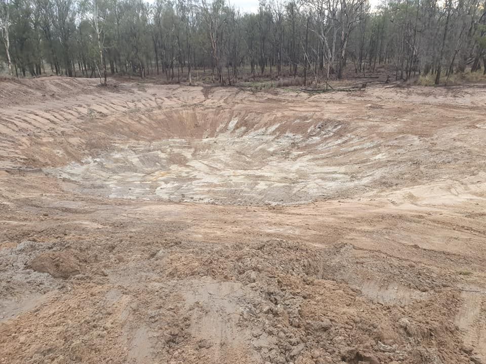 Large Barren Excavation Pit With Sandy Soil and a Tree LINE in the Background — Oakleigh Earthmoving in Kingaroy, QLD