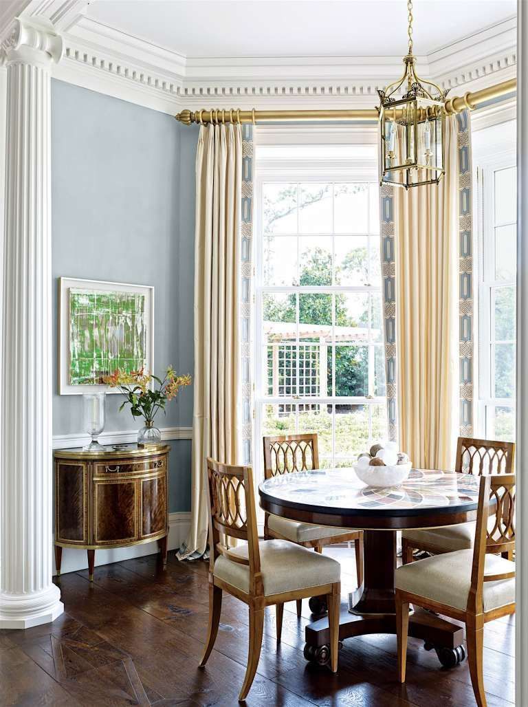 a dining room with a round table and chairs