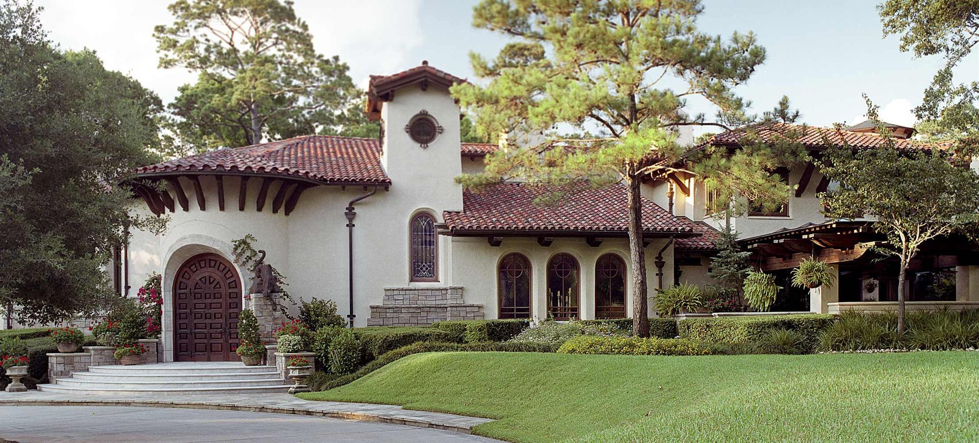 a large white house with a red tile roof