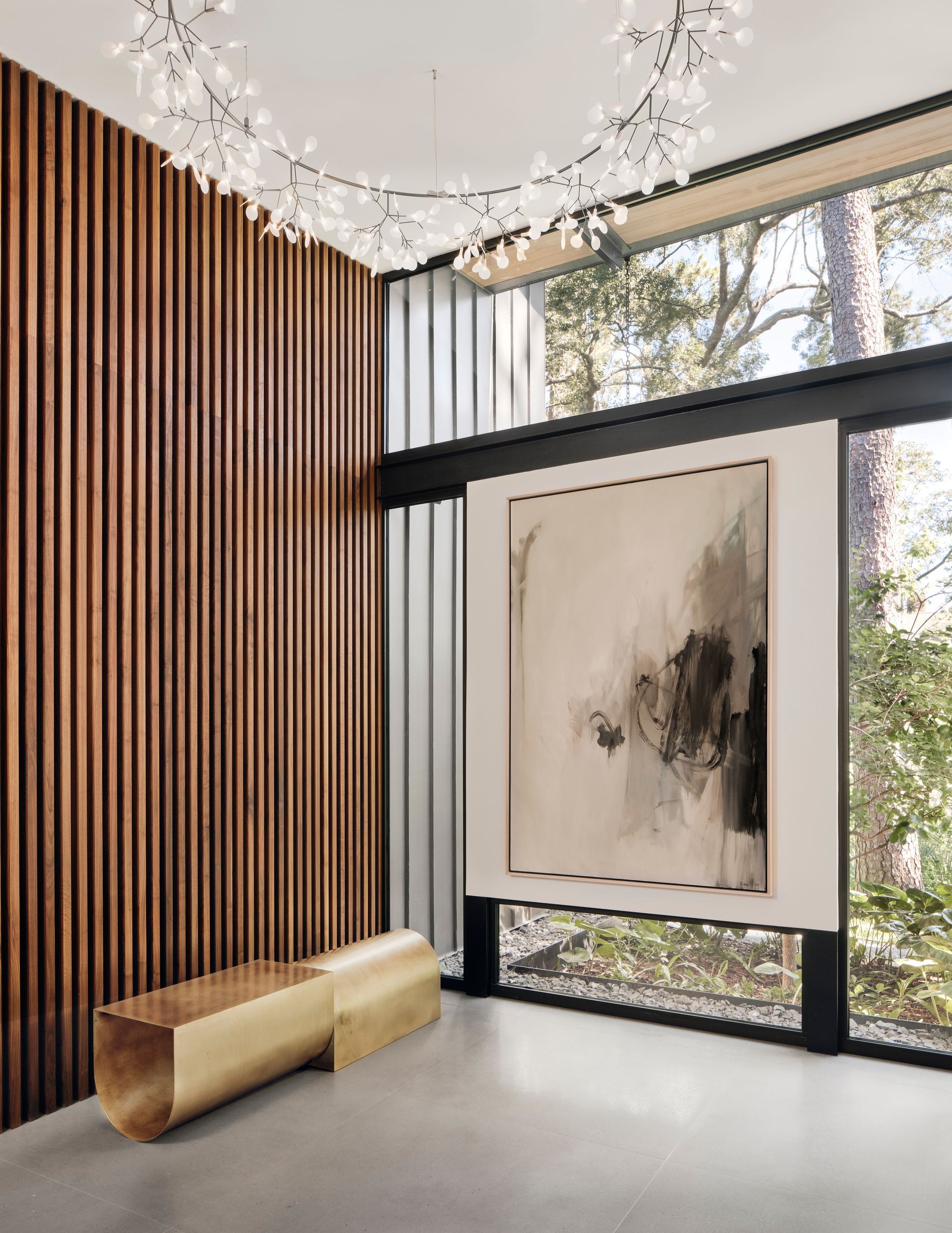 a room with a large window and a painting on the wall .