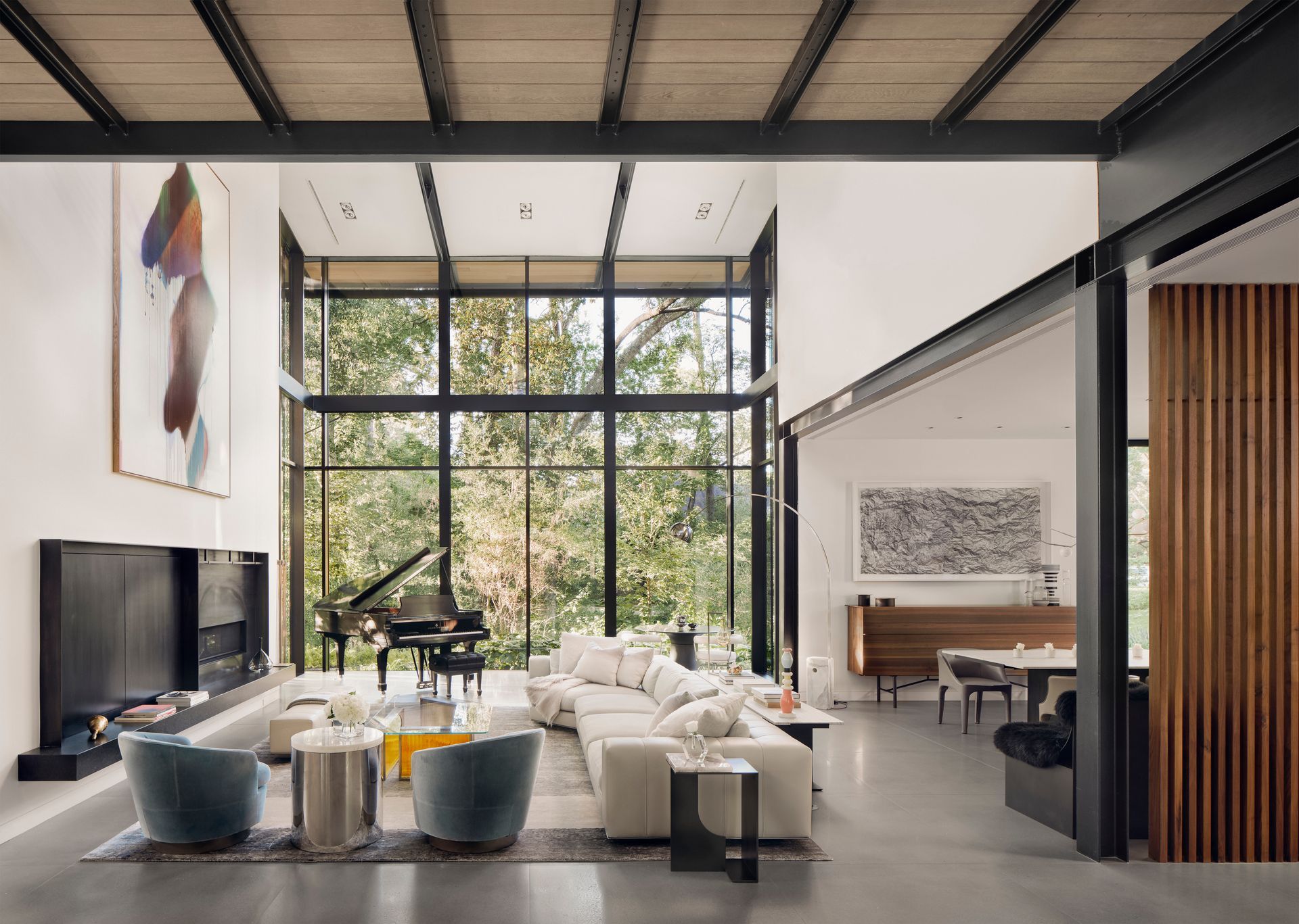 a living room with a piano and a lot of windows