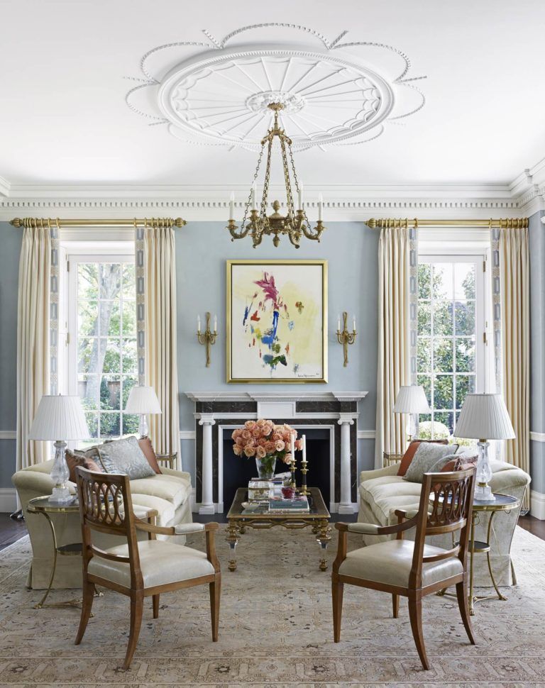 a living room with a fireplace and a painting on the wall