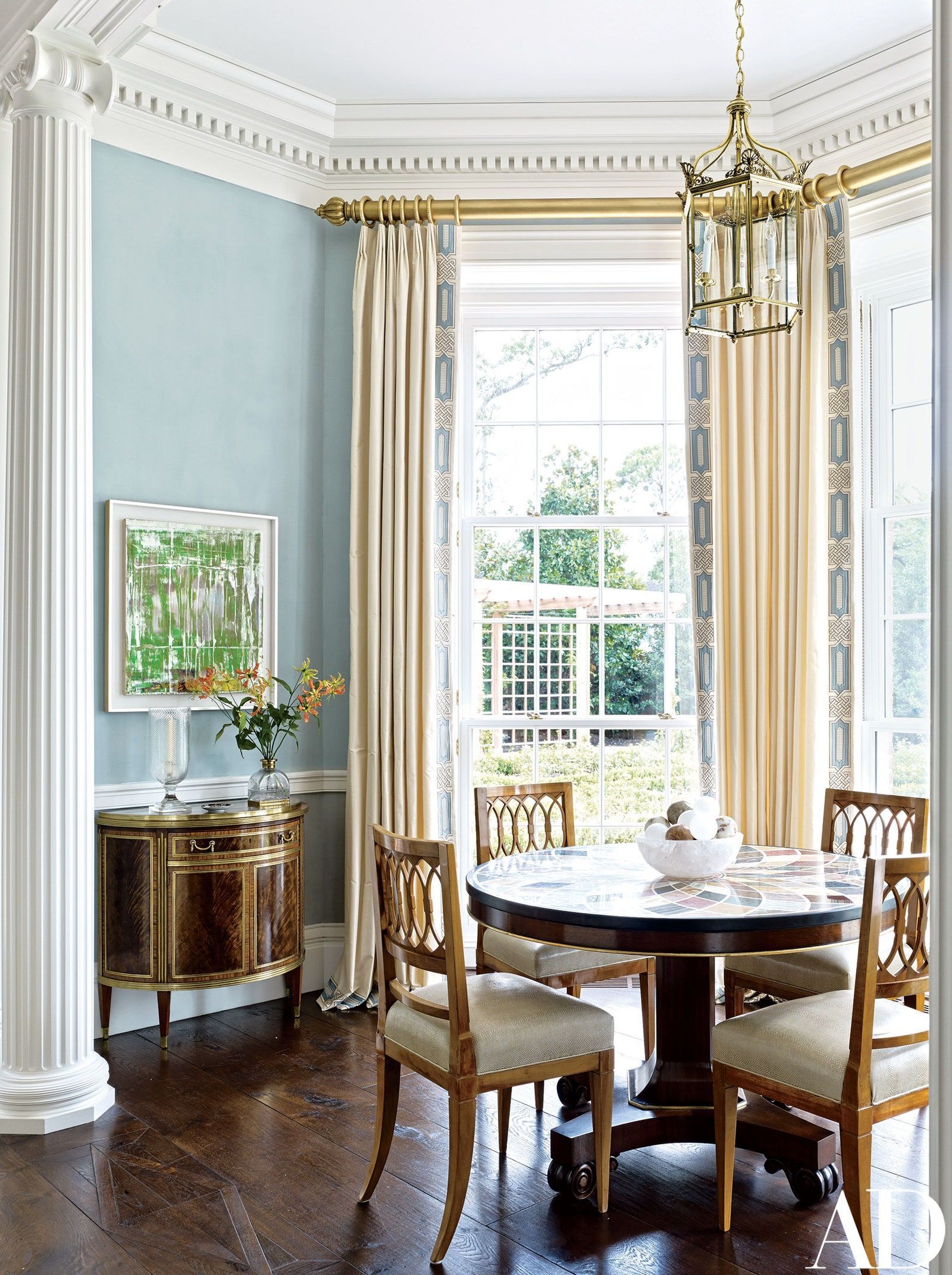 a dining room with a table and chairs and a window