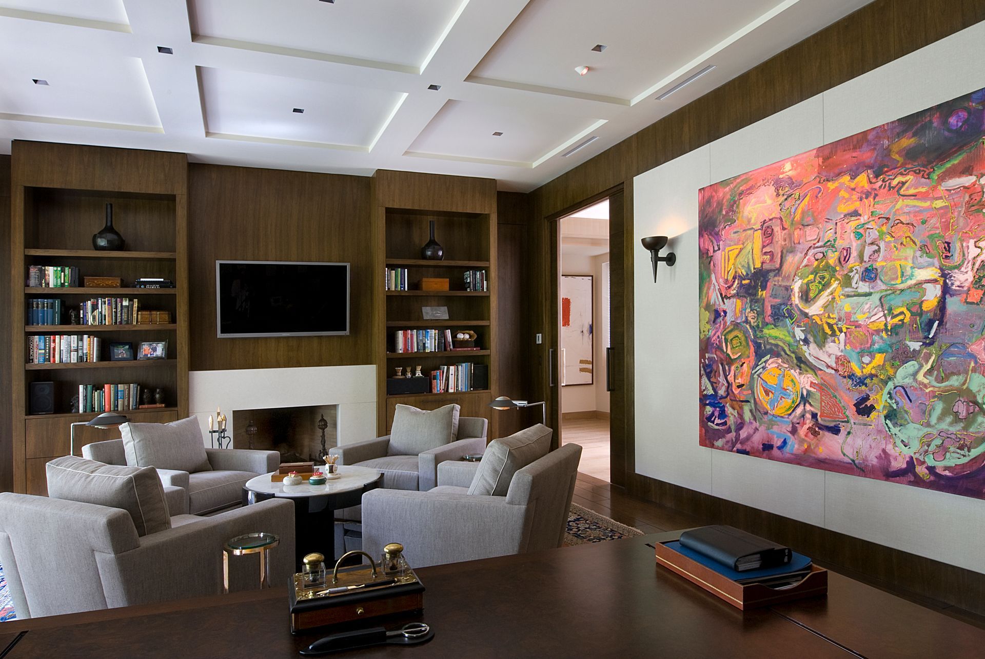 a living room with a large painting on the wall