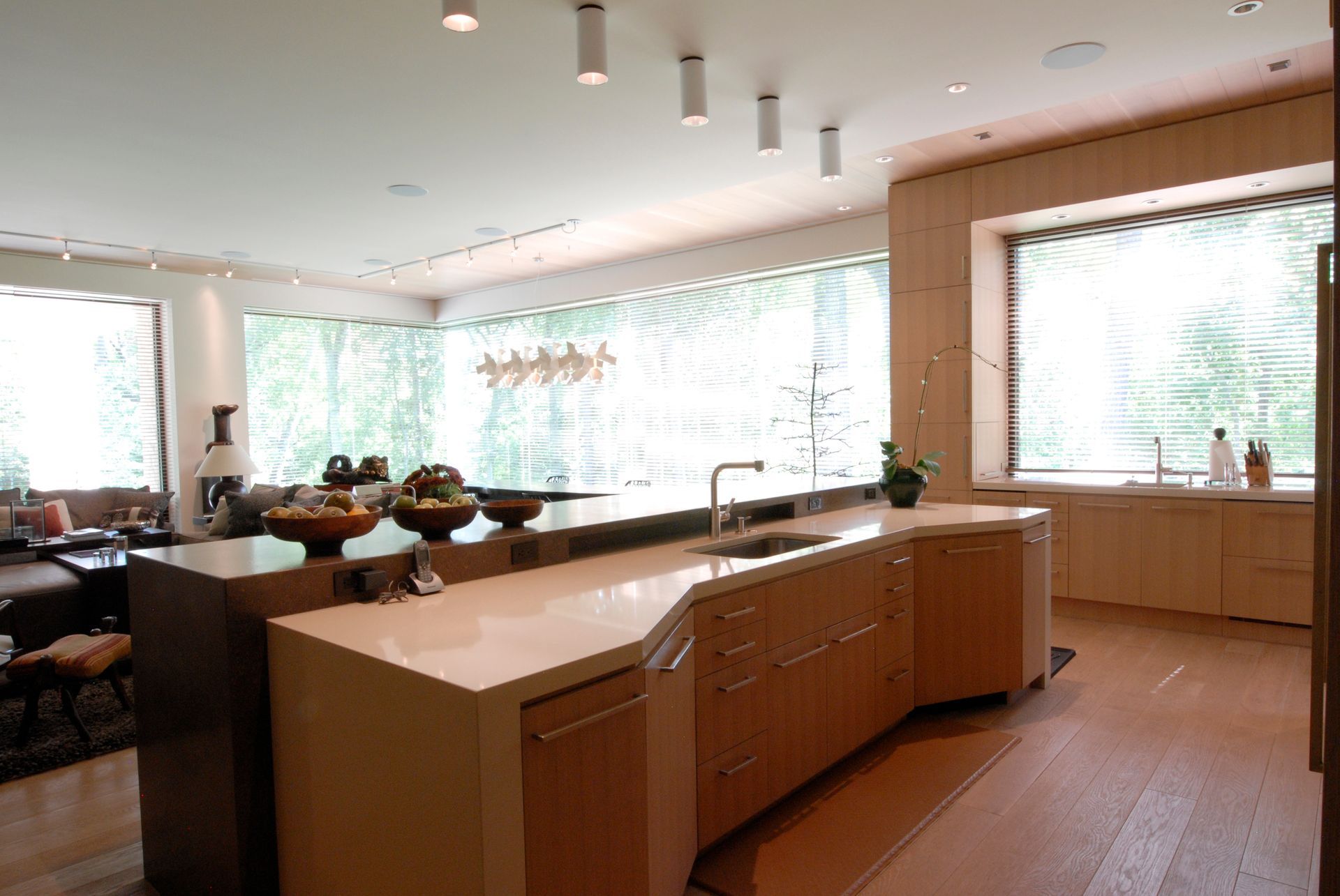 a kitchen with wooden cabinets and a large window