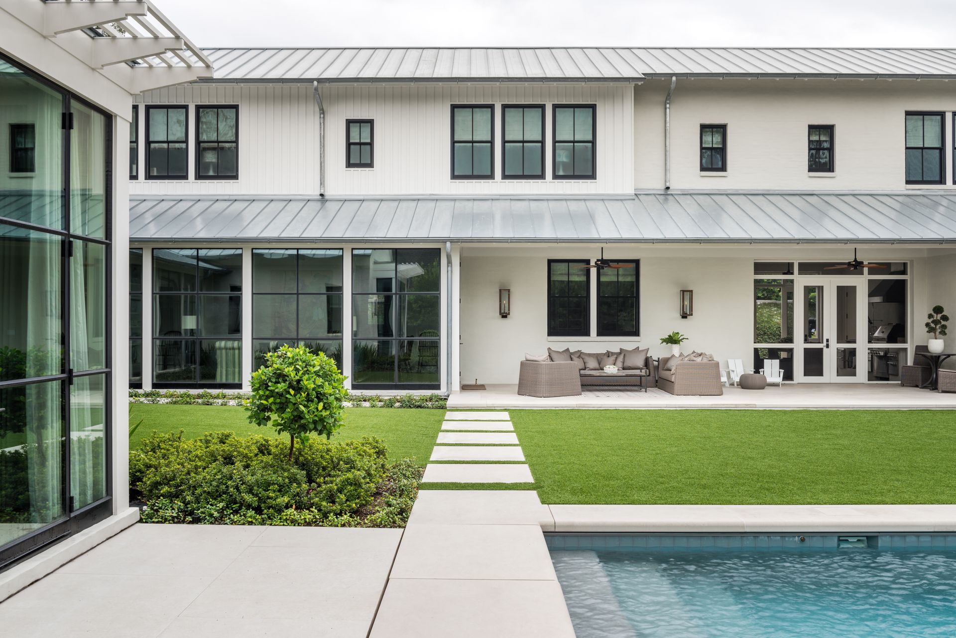 a large white house with a swimming pool in the backyard .