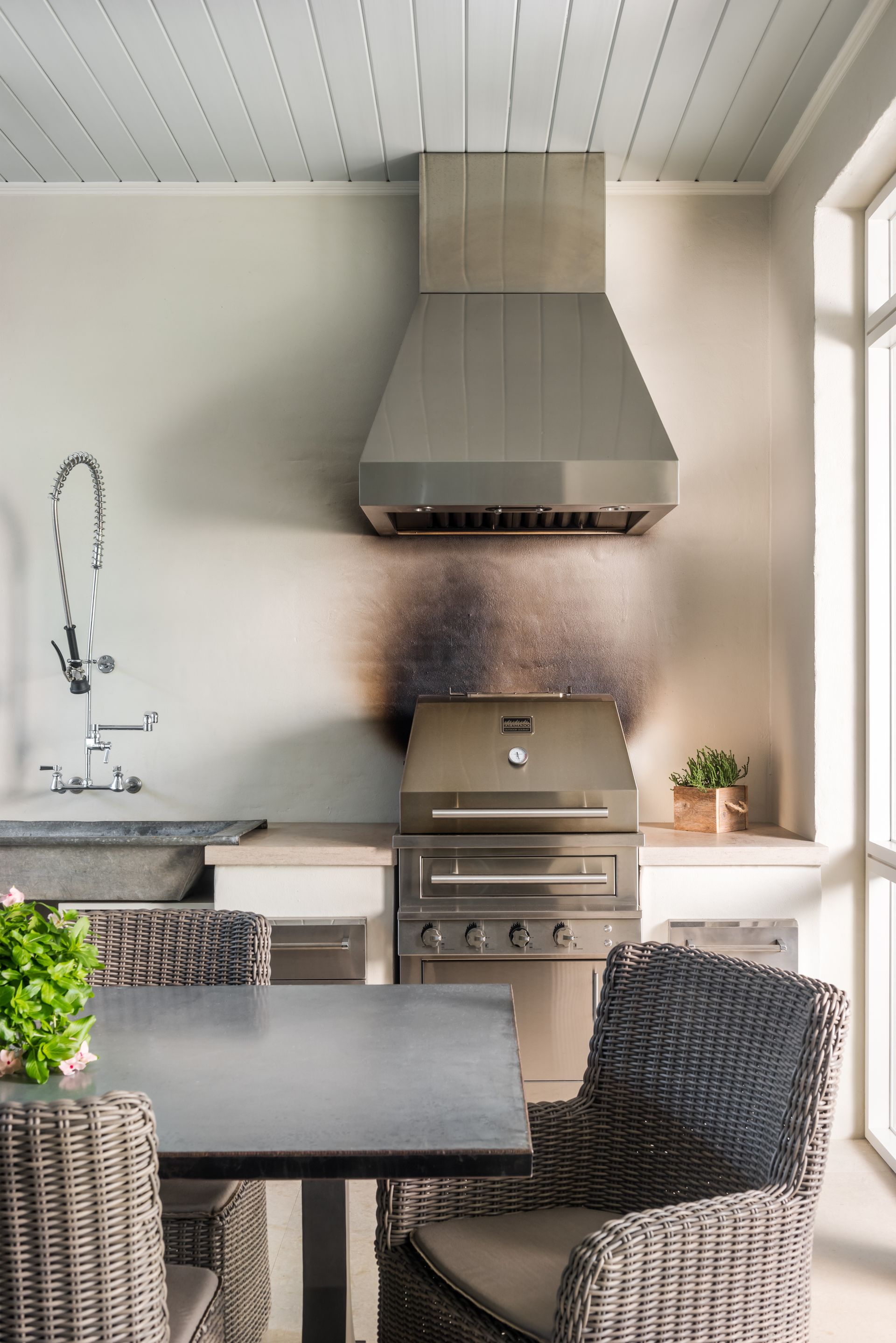 a kitchen with a table and chairs and a grill .
