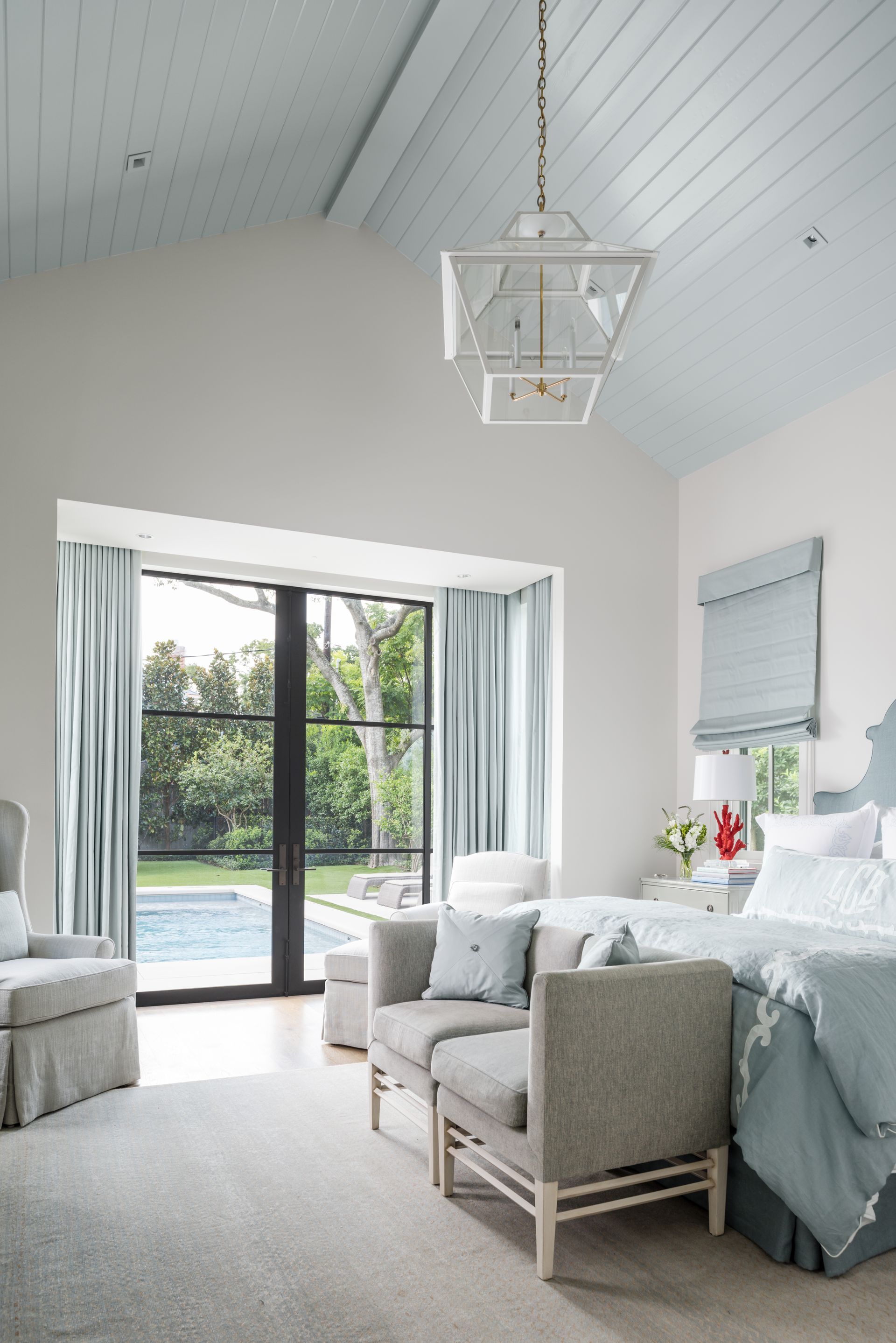 a bedroom with a large bed and a large window