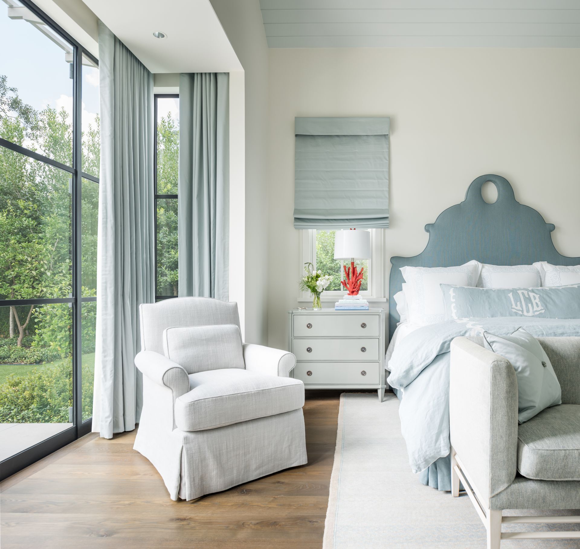 a bedroom with a bed a chair and a window