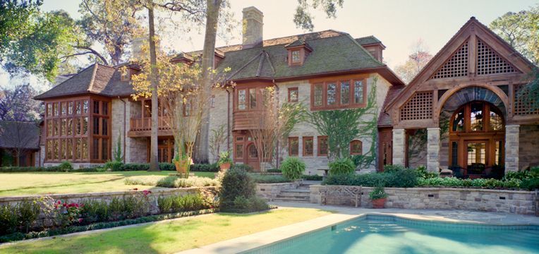 a large house with a swimming pool in front of it