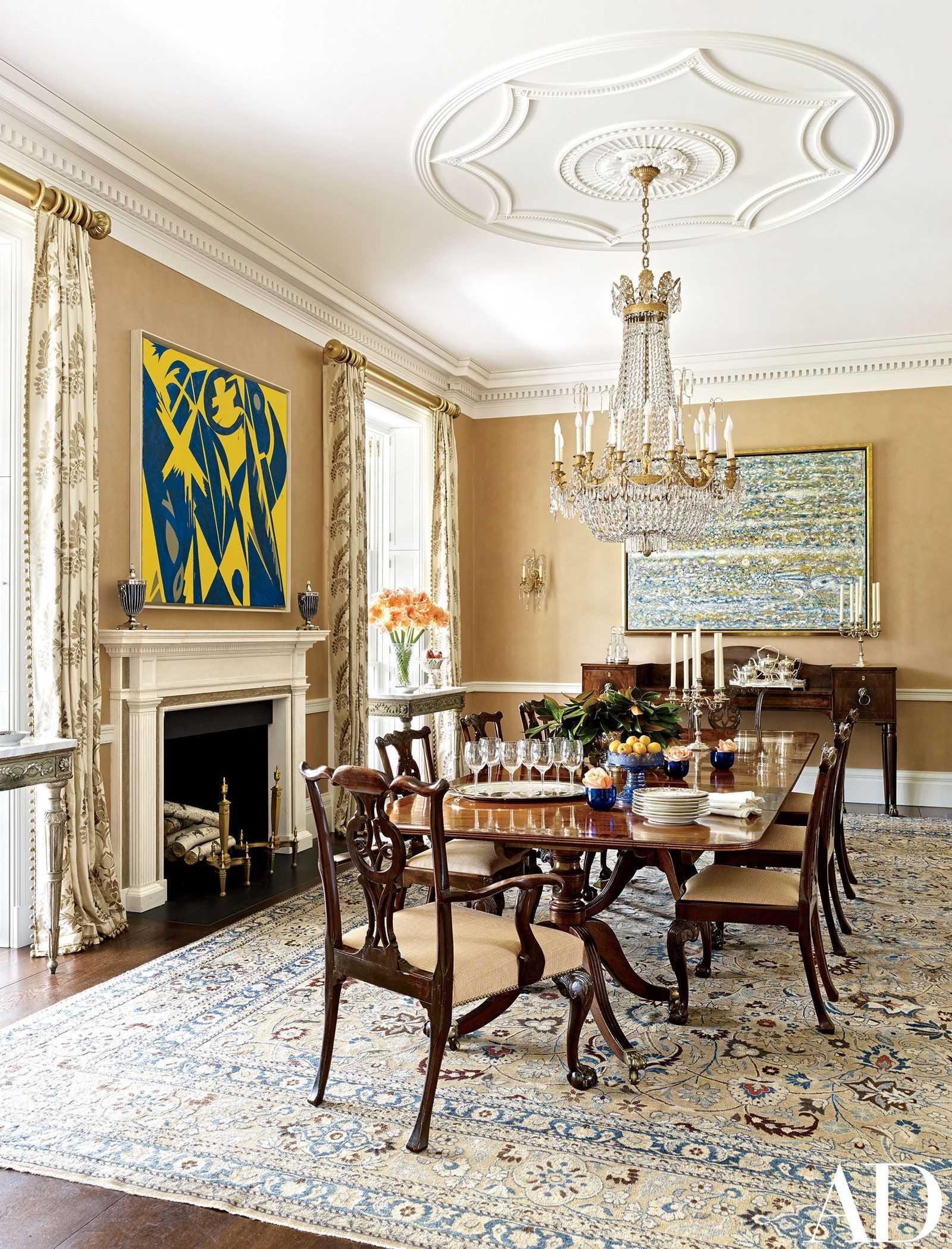 a dining room with a table and chairs and a chandelier .