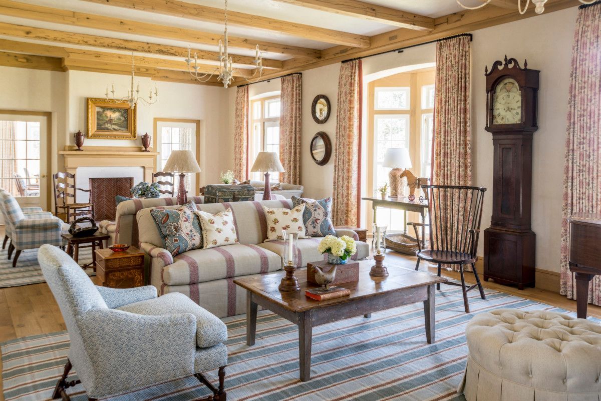 a living room filled with furniture and a large clock .