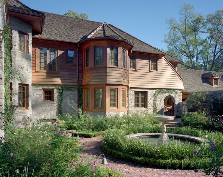 a large house with a fountain in front of it