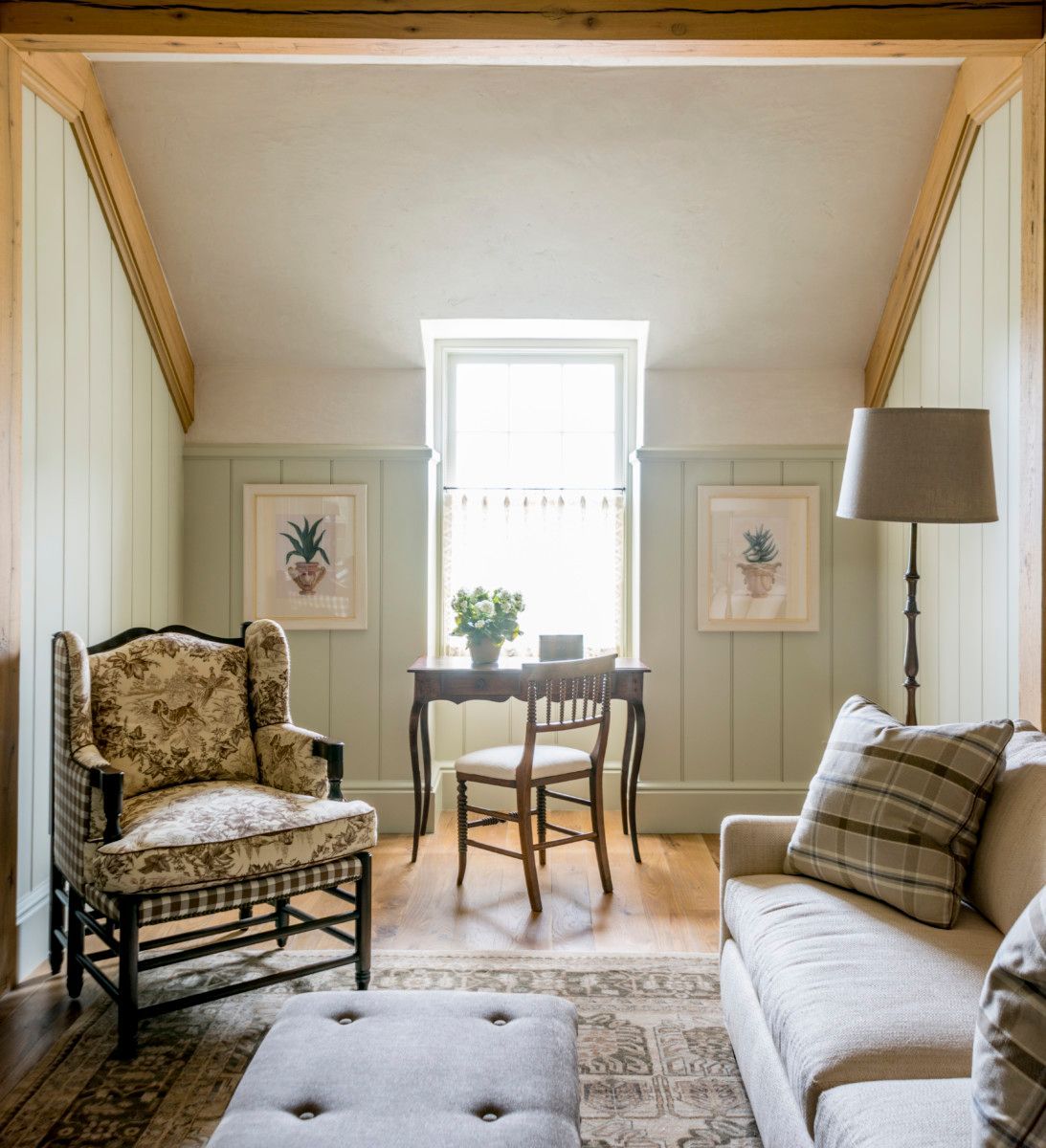 a living room with a couch a chair and a desk